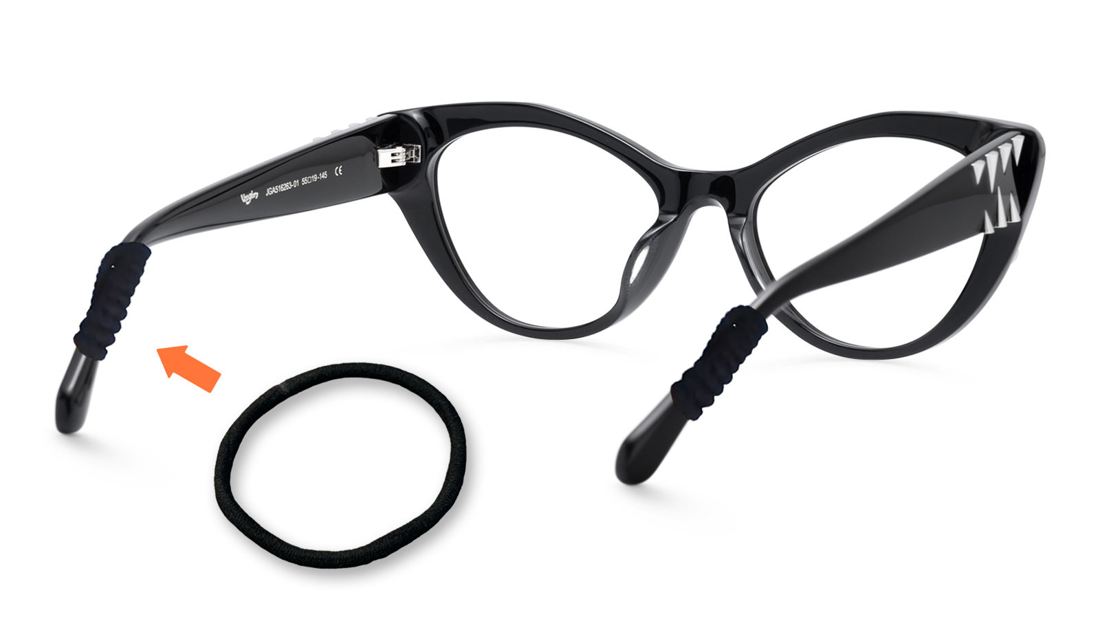 A pair of black cat-eye glasses with small black hair ties wrapped around the ends of the temple arms, next to a loose hair tie with an orange arrow pointing to one of the wrapped ties.