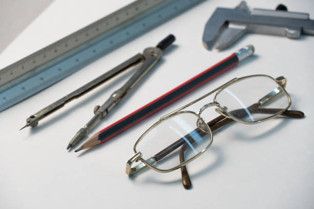 Metal frame glasses and some tools placed together