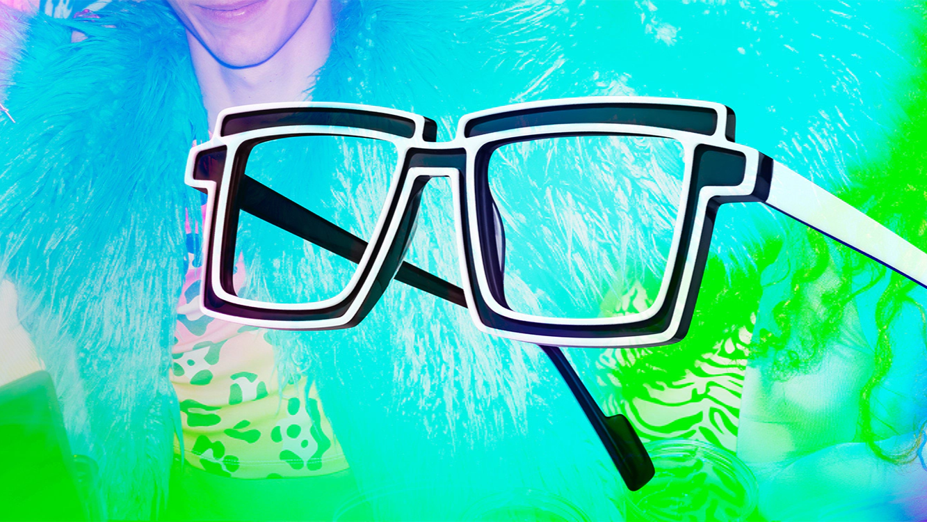 A person in a neon blue furry jacket wearing large, 8-bit style rave glasses as a fashion statement.