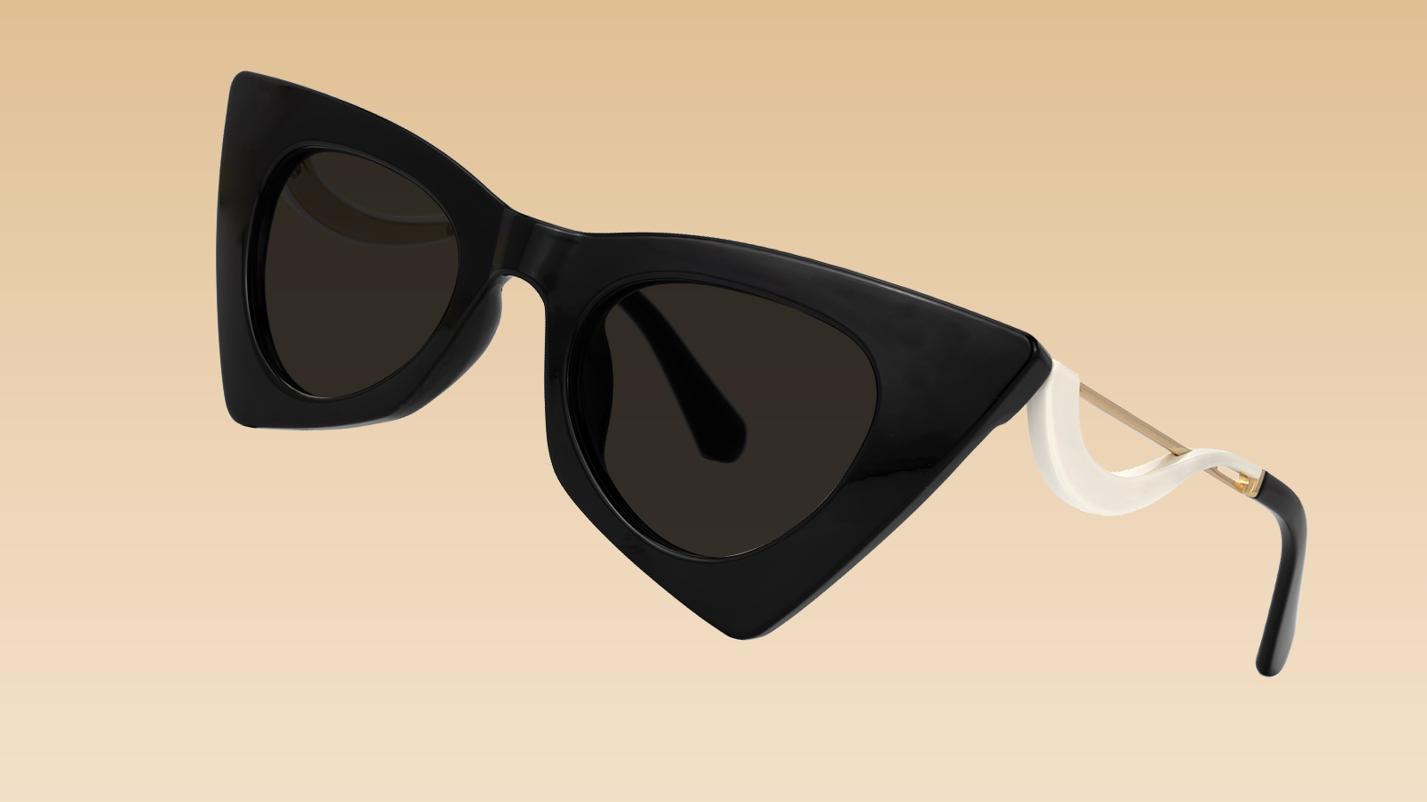 A pair of black, sculpted cat-eye sunglasses with a unique white-accented arm, illustrating a modern 2026 sunglasses trend.