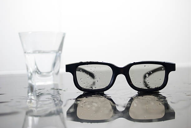 Spilled water from a glass on glasses