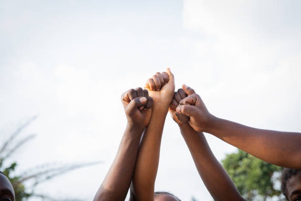 Fists raised in solidarity.
