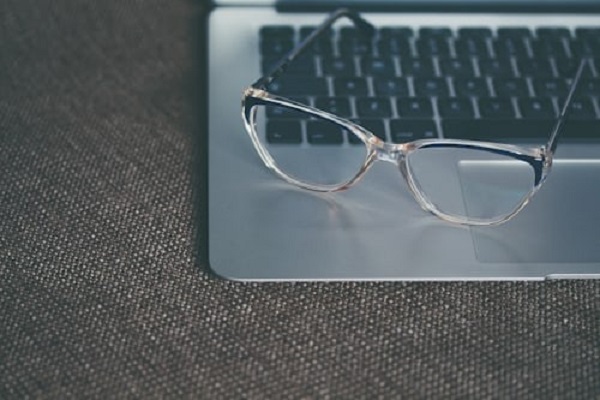 One pair clear frame glasses on laptop Aliis Sinisalu Unsplash