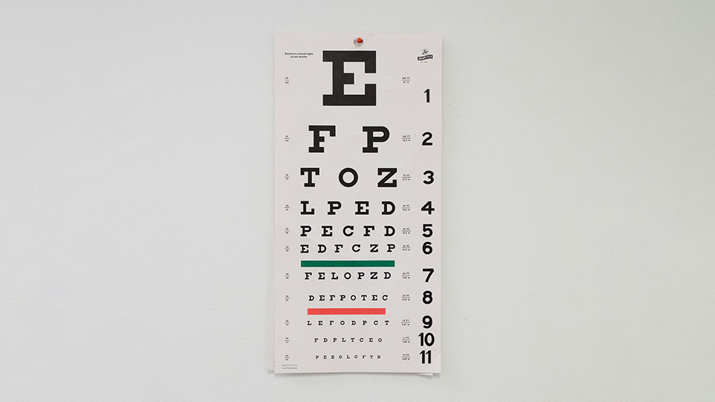 A standard eye exam chart on a wall, representing the importance of scheduling a comprehensive eye exam to check your vision.
