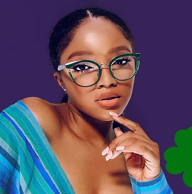 A confident woman wearing stylish green and retro cat-eye glasses