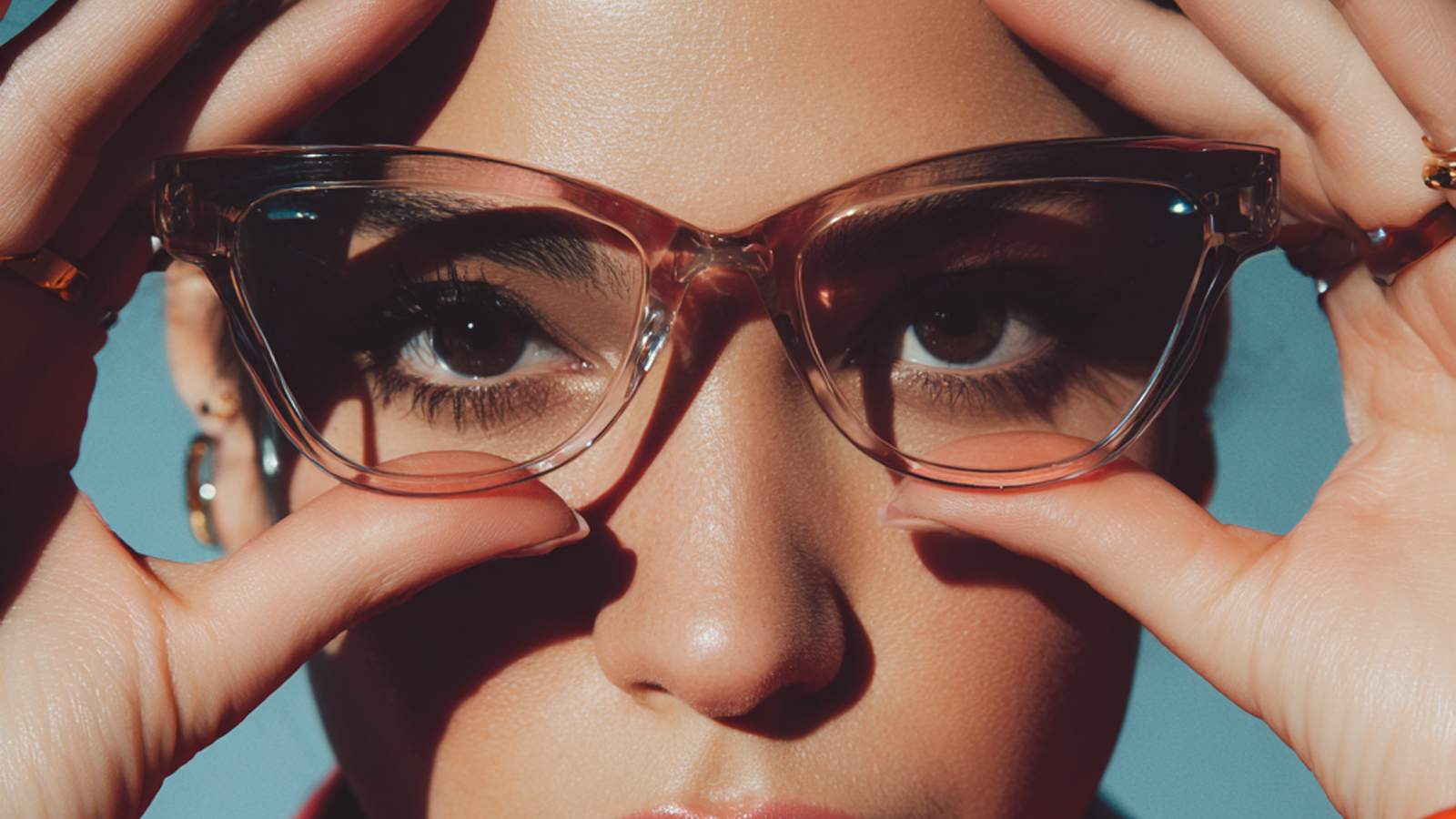 A woman holds up a new pair of clear glasses, representing the initial experience of adjusting to progressive lenses and seeing differently.
