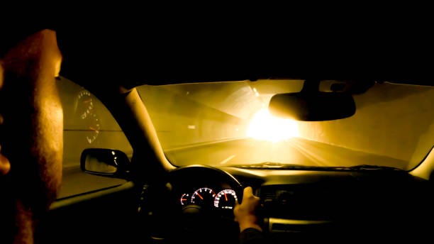 A man driving without wearing anti-glare glasses